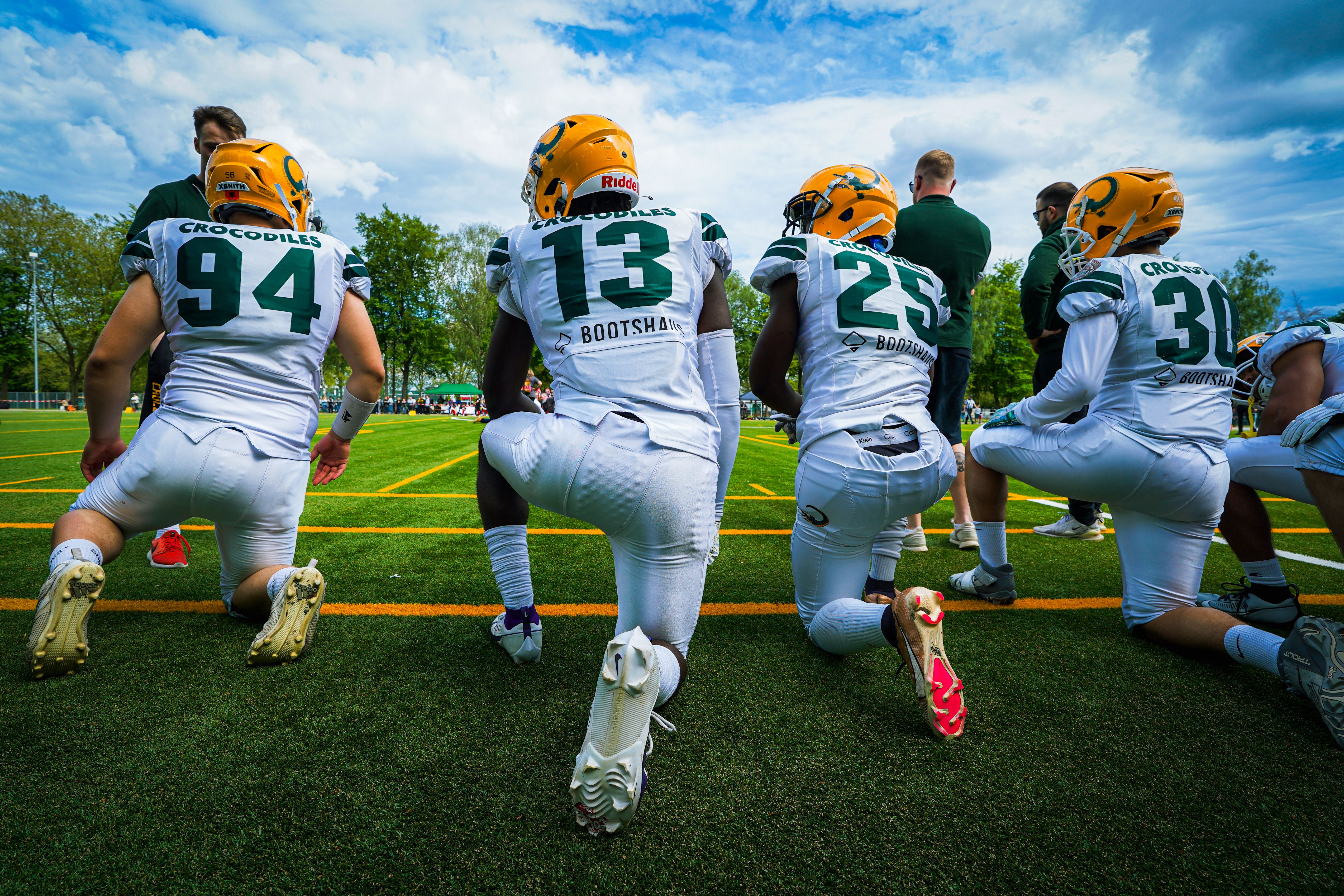Players kneeling together in a huddle